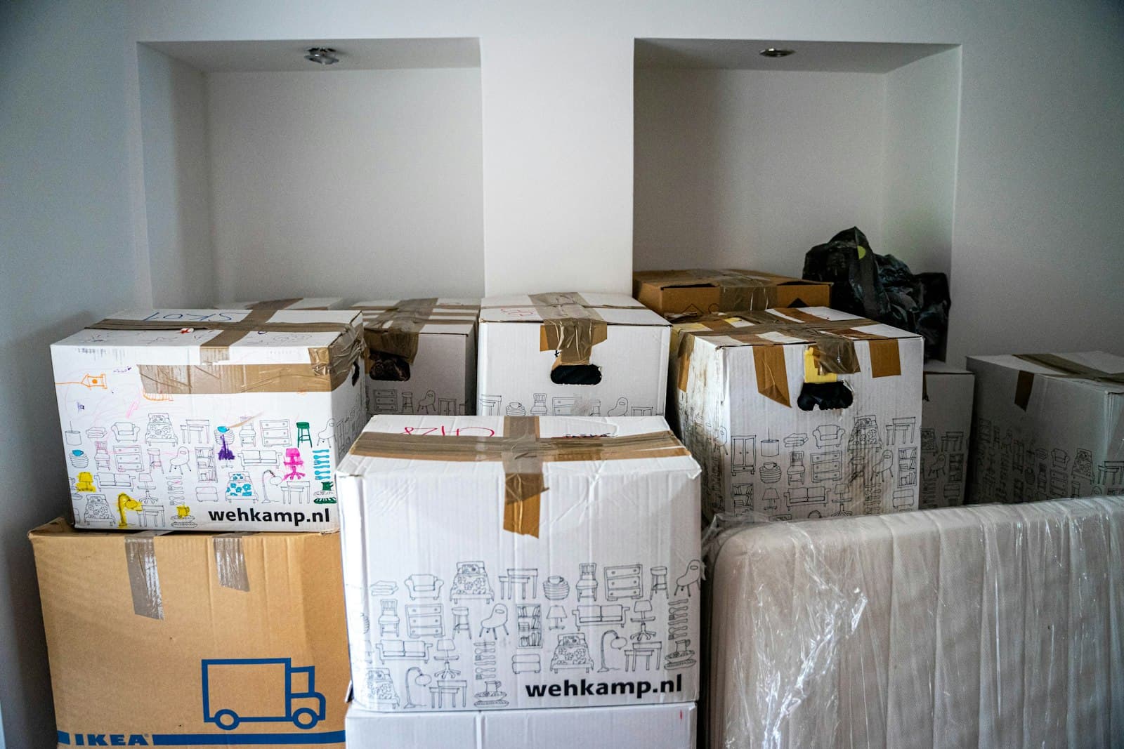 Professional packers wrapping and boxing belongings for an NYC move